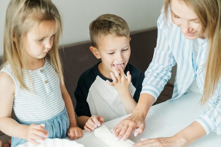 Mother and children enjoying cooking together, creating happy memories in the kitchen.